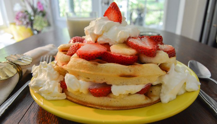 Waffles with whipped cream and strawberries St Francis Cottage