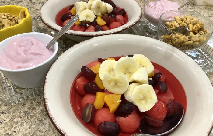Fruit salads with yogurt and granola toppings ready to serve