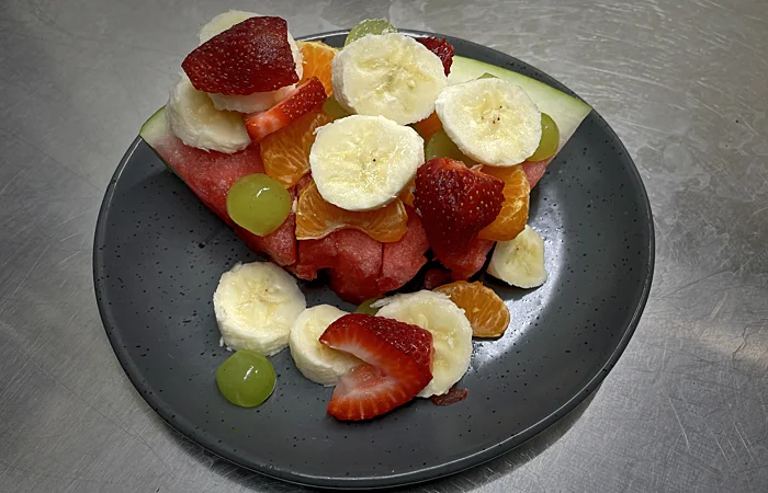 Watermelon based fruit salad with bananas and strawberries